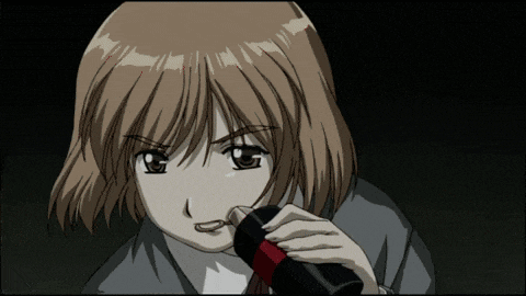 a close up of a girl holding a black object in her hand