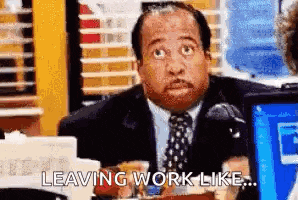 a man in a suit and tie is sitting at a desk and saying `` leaving work like ... '' .