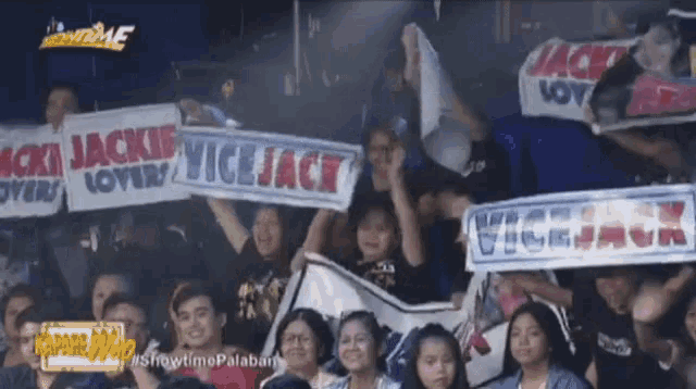 a crowd of people holding signs that say jackie vice jack