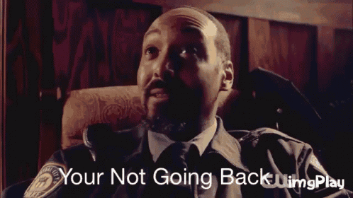 a man sitting in a chair with the words " your not going back " on the bottom