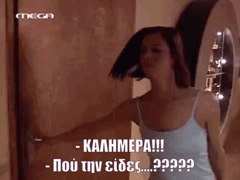 a woman in a white tank top is standing in front of a door that says mega