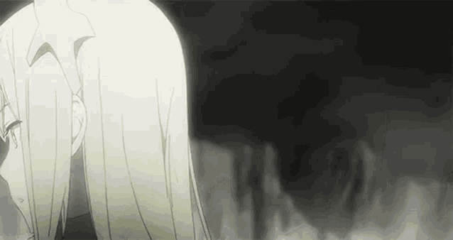 a black and white animated gif of a girl with long blonde hair standing in front of a fire .