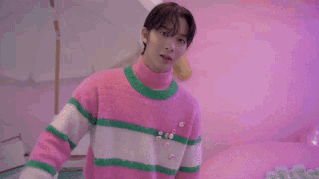 a close up of a person 's face with their eyes closed in a pink room .