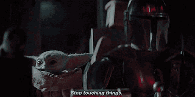 a man in a helmet is holding a baby and says stop touching things