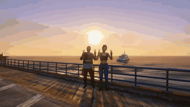 a man and a woman giving a peace sign on a pier at sunset