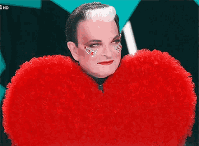 a man is wearing a red heart shaped costume