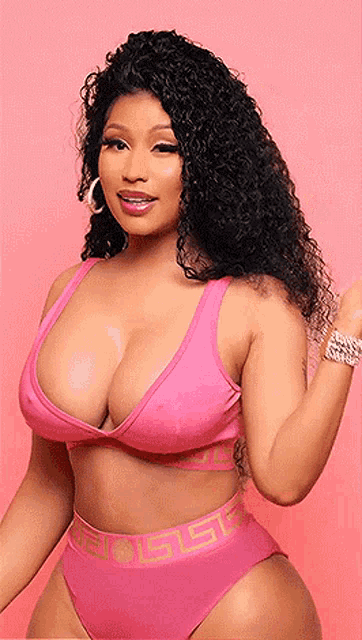 nicki minaj is wearing a pink bikini top and bottoms with a greek key design on the waistband .