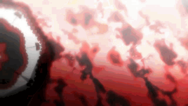a blurred image of a red and white background with a few pieces of paper floating in the air