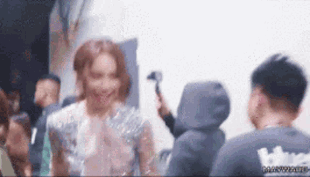 a blurry picture of a woman talking to a man in a hoodie