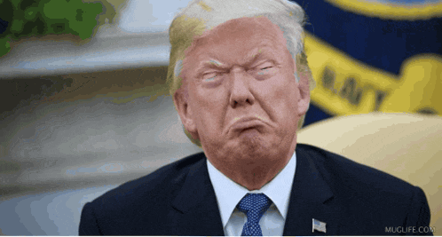 donald trump making a funny face in front of a flag that says navy on it