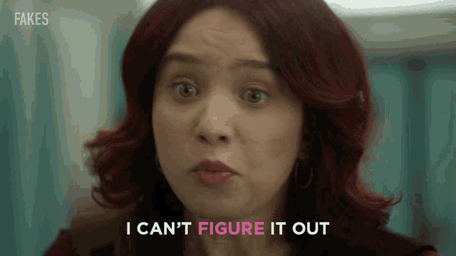 a woman with red hair is making a funny face and says i can 't figure it out