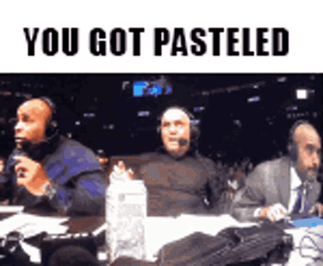 three men wearing headphones are sitting at a table with the words " you got pasteled " above them .