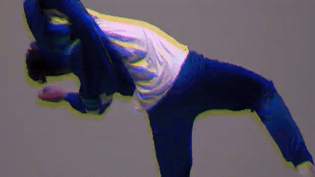 a man in a blue jacket is doing a flip