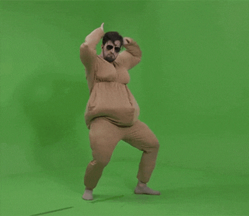 a man in a costume dancing on a green screen