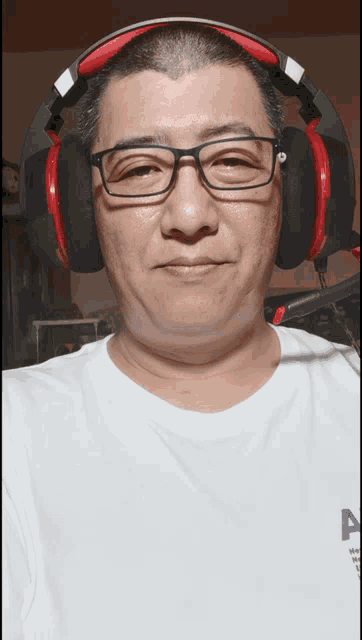 a man wearing glasses and headphones is wearing a white shirt that says ' a ' on it