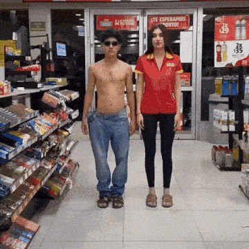 a man and a woman are standing in a store with a sign that says te esperamos pronto