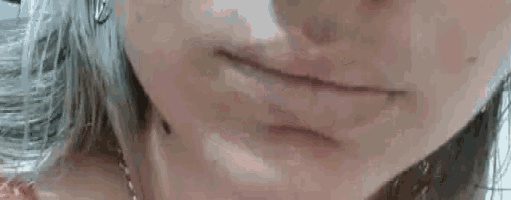 a close up of a woman 's mouth with a slight smile .