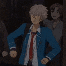 a man in a blue suit and tie is dancing