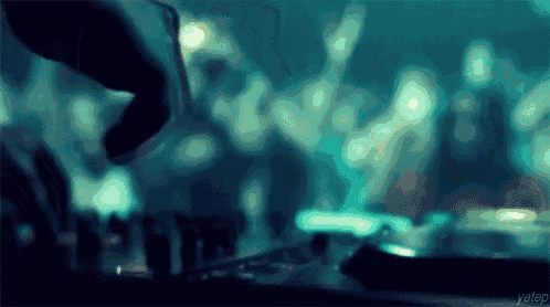 a blurred image of a dj playing music with the word yetep in the bottom right corner