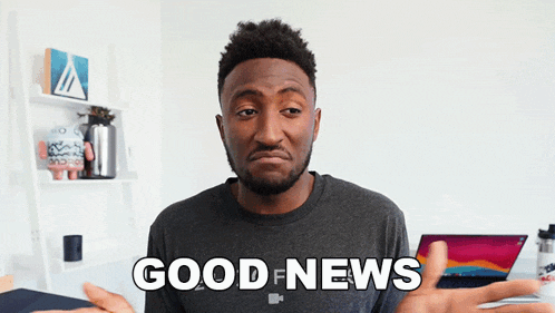 a man says good news in front of a laptop computer