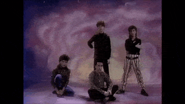 a group of people standing next to each other on a stage .