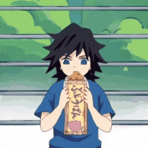 a boy in a blue shirt is eating a piece of bread .