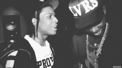 a black and white photo of two men standing next to each other