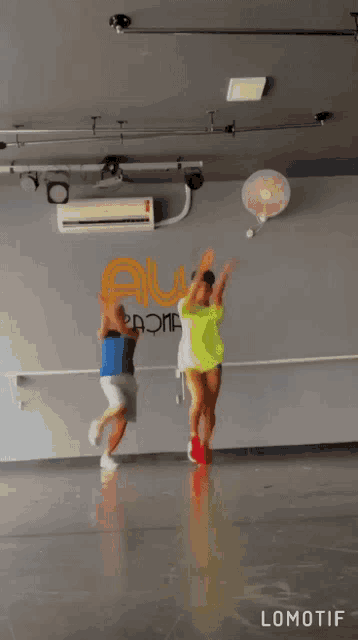 a couple of people are dancing in a room with the word lomotif on the bottom