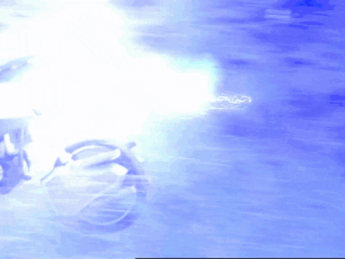 a blurred image of a motorcycle with a blue background