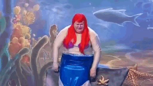 a man with red hair is dressed as a mermaid .