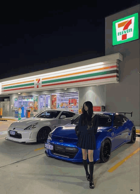 a woman stands in front of a 7 eleven