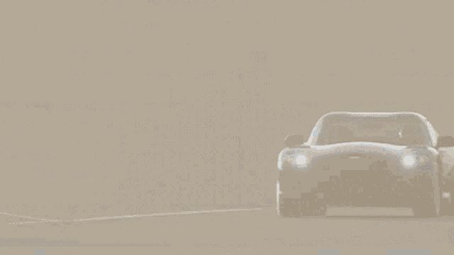 a car is driving on a foggy road with a gazebo in the background