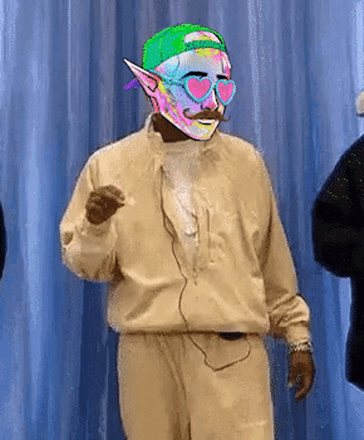 a man wearing a colorful mask and sunglasses is dancing .