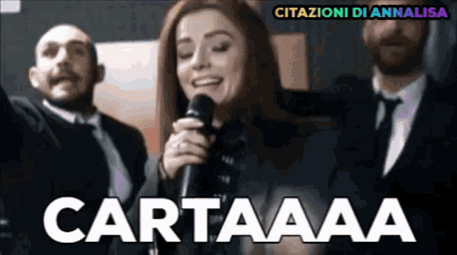 a woman singing into a microphone with the words cartaaaa written in the corner