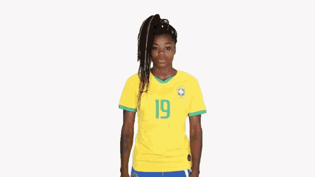 a woman wearing a soccer jersey with the number 19 on it