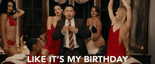 a man in a suit and tie is surrounded by women in red dresses and the words like it 's my birthday are above him