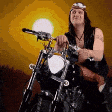 a man with long hair is riding a motorcycle