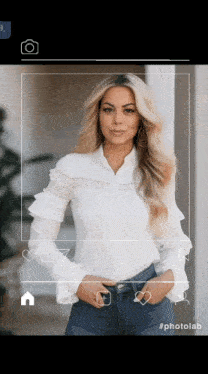a woman in a white shirt and blue jeans is being photographed by a photolab app