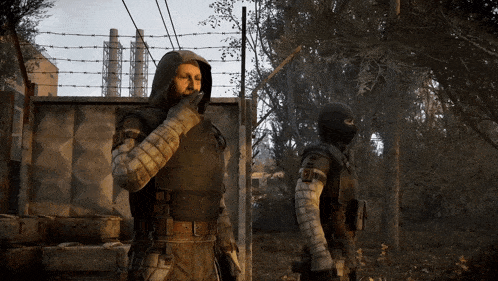 two soldiers are standing next to each other with one wearing a mask and the other wearing a hood