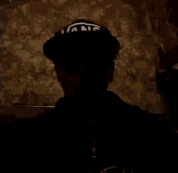 a person wearing a hat that says ' a ' on it