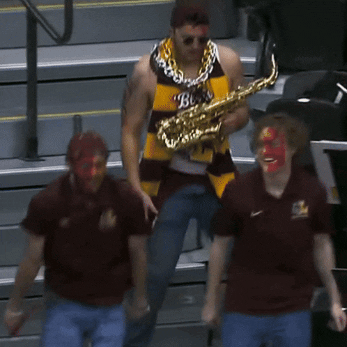 a man playing a saxophone with a shirt that says bruins