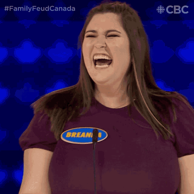 a woman wearing a purple shirt that says breanna on it