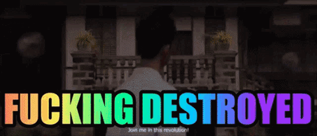 a man standing in front of a building with the words " fucking destroyed " above him