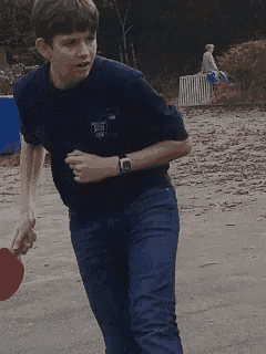 a boy wearing a shirt that says ' ucsd ' on it is running
