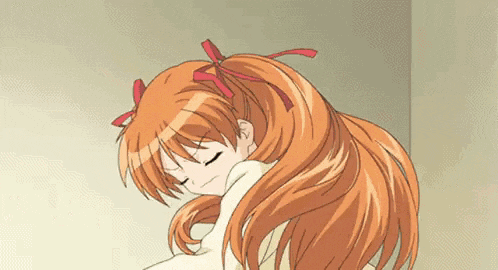a girl with long red hair is laying down with her eyes closed and a bow in her hair .