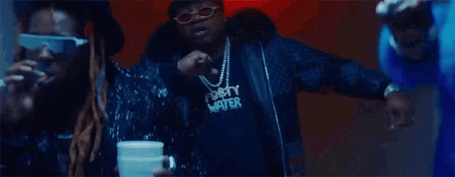 a man wearing a shirt that says forty waves is dancing with two other men