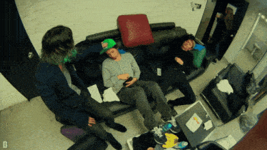 a group of people laying on a couch with the letter d on the bottom