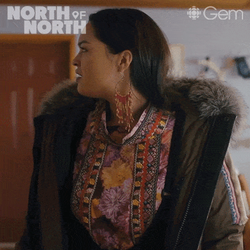 a woman is wearing a floral shirt and a fur hooded jacket with the word north of north on the bottom