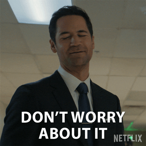 a man in a suit and tie has his eyes closed and says " don 't worry about it "