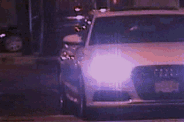 a close up of a car 's headlights with a purple light coming out of it